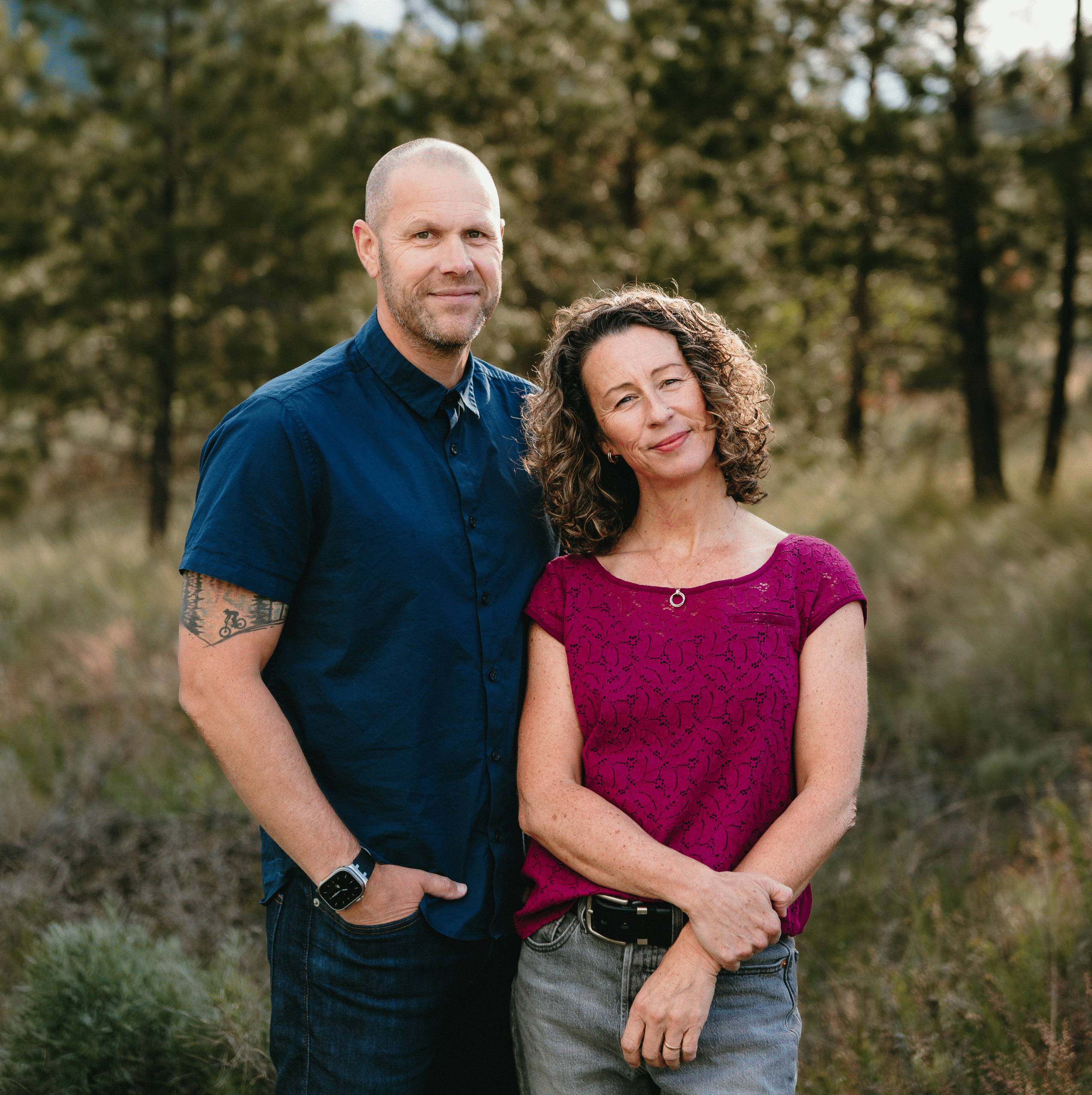 Meet Darren and Claire Jones Darren and Claire Jones standing together in a field with trees behind them.